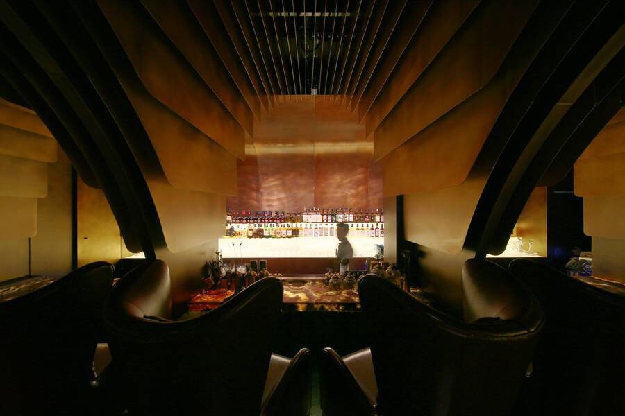 Bar area of the MS-II Restaurant, where a jade-like counter and intimate two-person seats create a small-scale dining and drinking space.