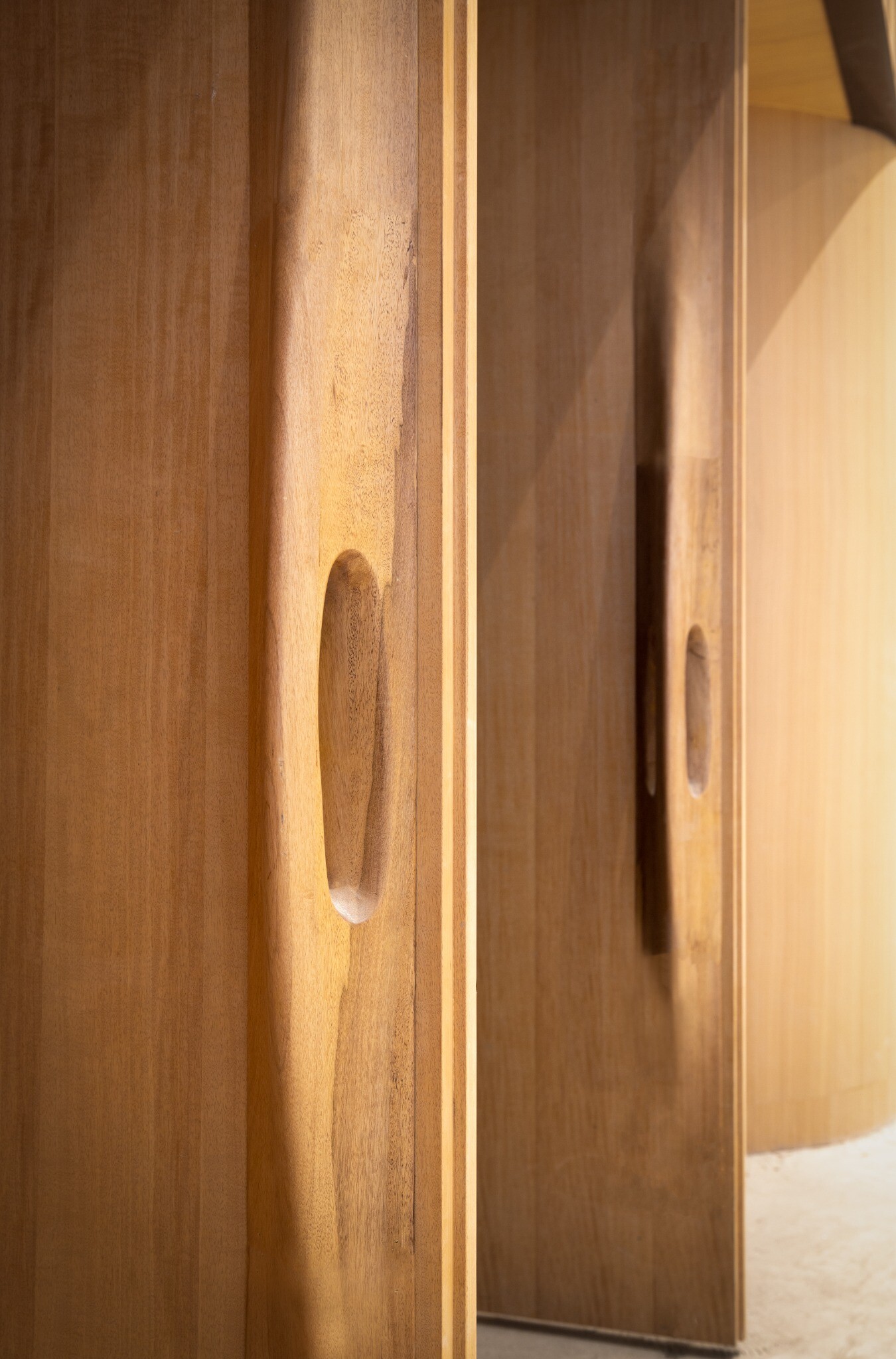Detail of a wood-veneer door handle in the West Wing Art Museum.