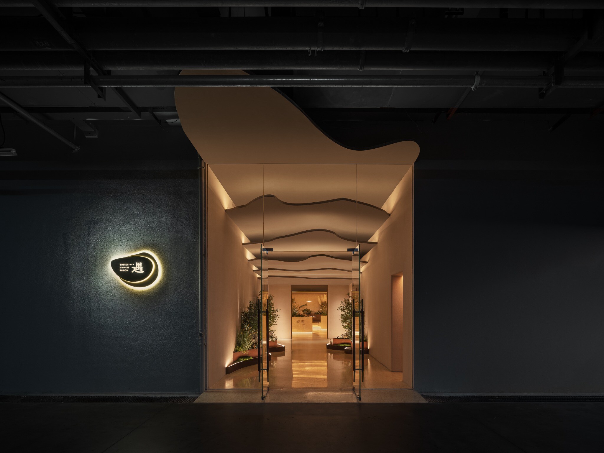 Rock-like ceiling installation at the underground entrance of YiXing YU Restaurant, creating a cave-like arrival experience.